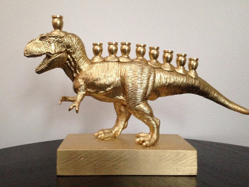 A "Menorasaurus" -- a Hannukiah made by gluing candle holders to a plastic T-Rex, mounting it on a wooden base, and spray painting the whole thing gold