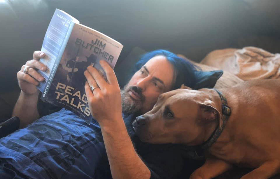 Jim reads Peace Talks with his pit bull Brutus reading over his shoulder. Bru looks deeply concerned about the fates of his friends!